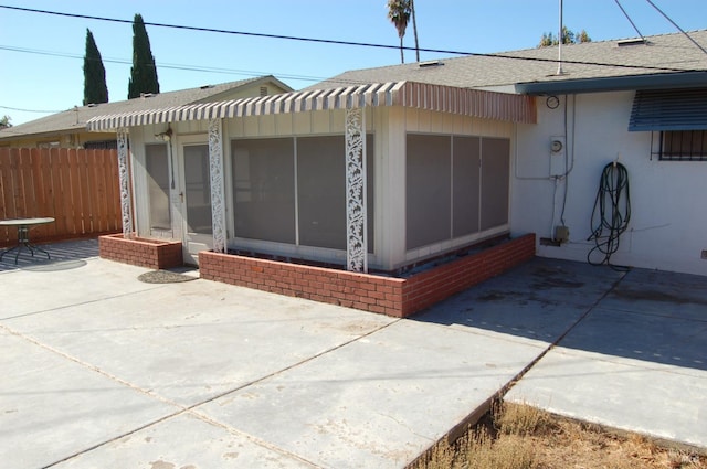 view of property exterior with a patio area