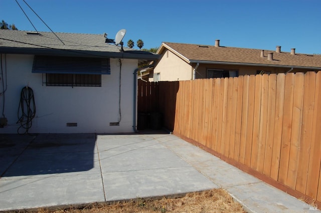 view of side of property with a patio area