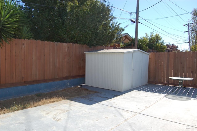 view of patio / terrace with a storage shed