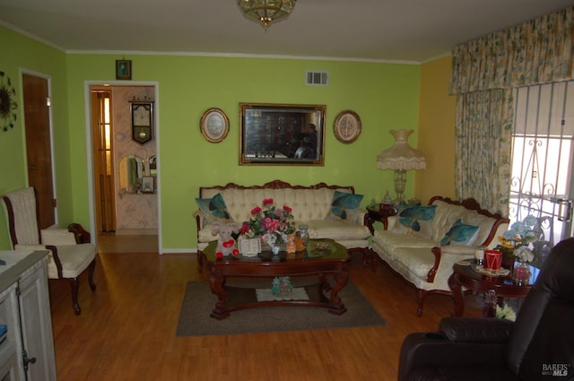 living room with light hardwood / wood-style floors and ornamental molding