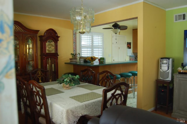 dining area with ceiling fan with notable chandelier and ornamental molding