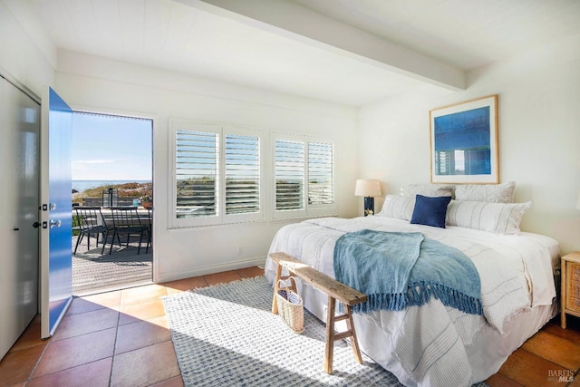 bedroom featuring beam ceiling, tile patterned flooring, baseboards, and access to outside