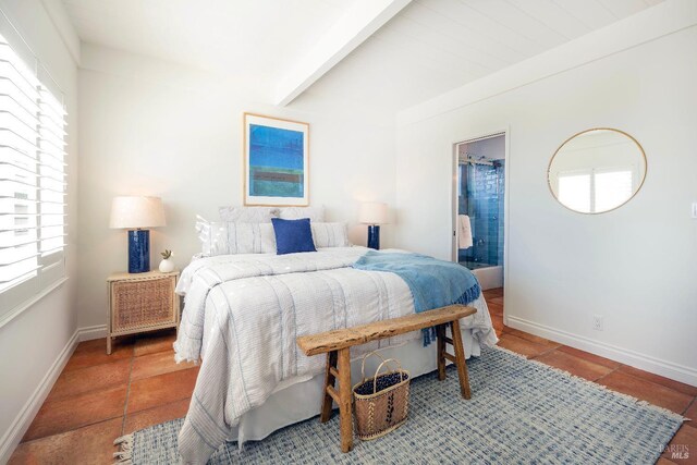 bedroom featuring connected bathroom and beam ceiling