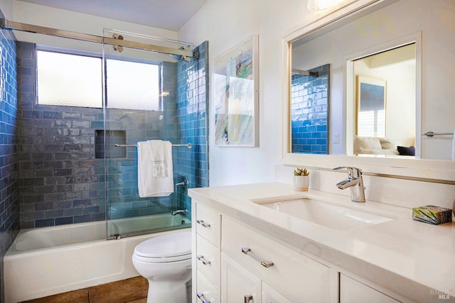 full bathroom with vanity, enclosed tub / shower combo, toilet, and tile patterned flooring