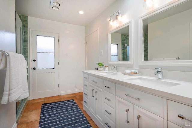 bathroom with vanity, an enclosed shower, and tile patterned floors