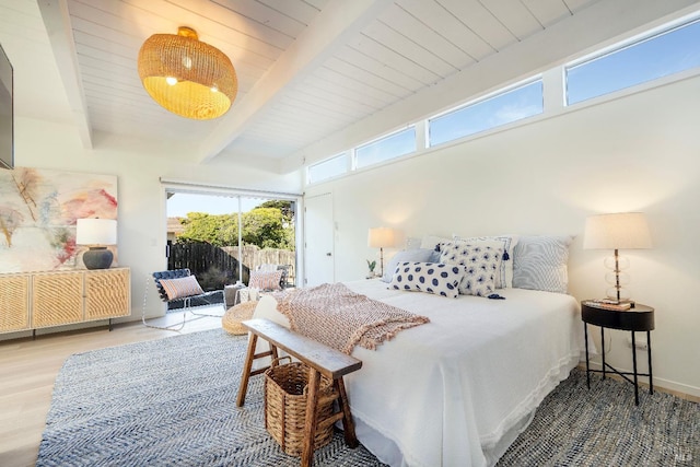 bedroom featuring beamed ceiling, wood finished floors, wooden ceiling, baseboards, and access to exterior