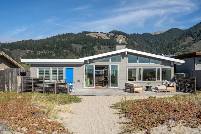 rear view of house featuring a patio, a mountain view, and outdoor lounge area