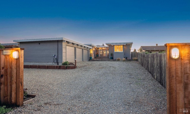 exterior space with an attached garage, driveway, and fence
