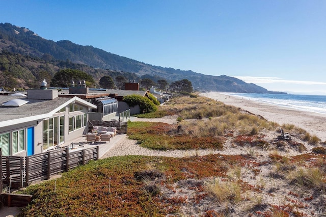 mountain view featuring a water view and a view of the beach