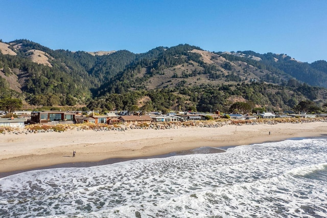 property view of mountains featuring a water view and a beach view