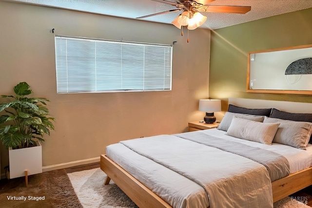 bedroom featuring a textured ceiling, carpet floors, and ceiling fan