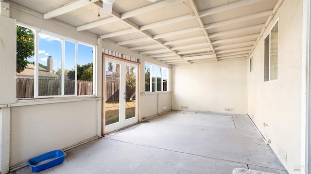 unfurnished sunroom featuring ceiling fan