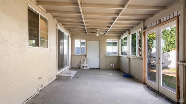 unfurnished sunroom featuring ceiling fan