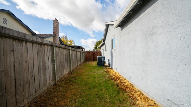 view of home's exterior with a yard and central AC unit