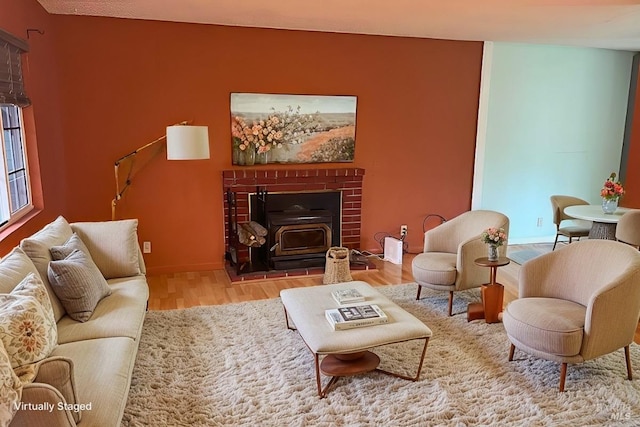 living room with light wood-type flooring and a wood stove