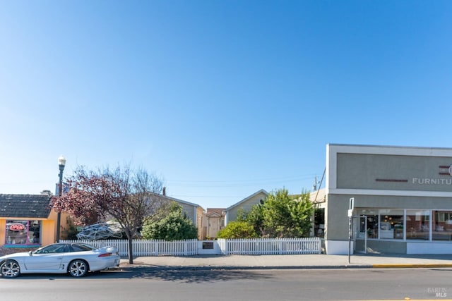 view of building exterior with fence