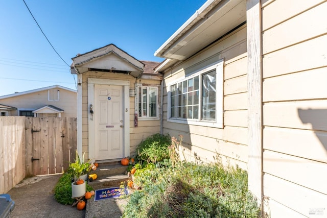 doorway to property featuring fence