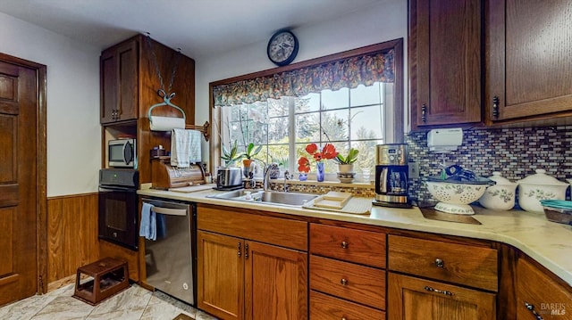 kitchen featuring stainless steel appliances, sink, and backsplash