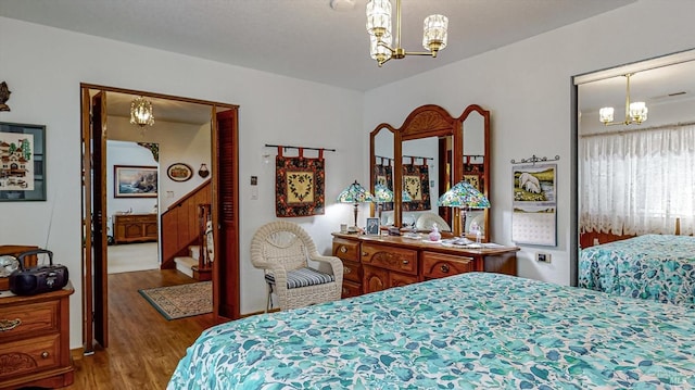 bedroom featuring a notable chandelier and wood-type flooring