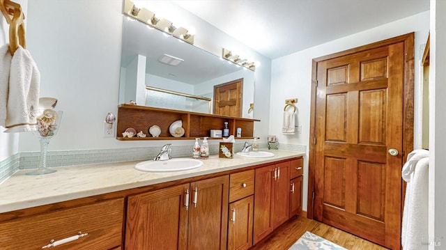 bathroom with vanity, wood-type flooring, and walk in shower