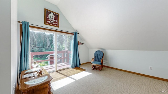 living area with a wealth of natural light, carpet, and vaulted ceiling