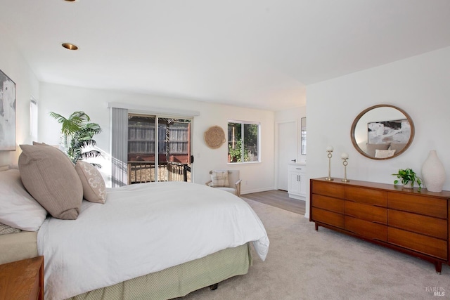 bedroom featuring access to outside and light carpet