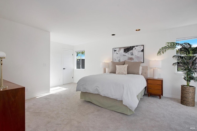 bedroom featuring baseboards and light colored carpet