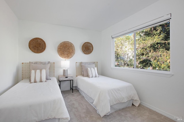 bedroom with carpet flooring and baseboards