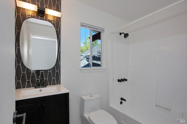 bathroom with toilet, tasteful backsplash, shower / bathing tub combination, and vanity