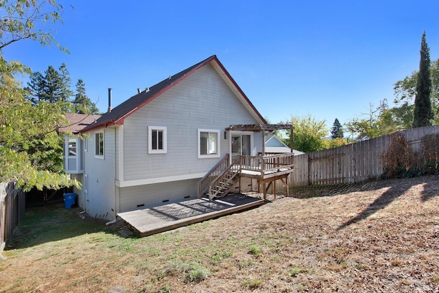 rear view of house with a lawn, crawl space, a fenced backyard, a wooden deck, and stairs