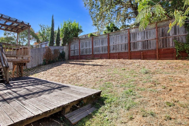 view of yard featuring fence and a wooden deck