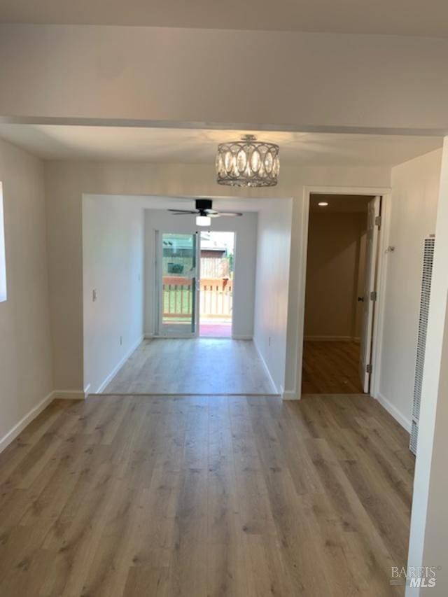 empty room with wood-type flooring and ceiling fan