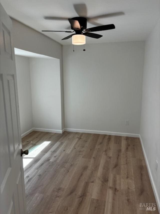 spare room featuring ceiling fan and light wood-type flooring