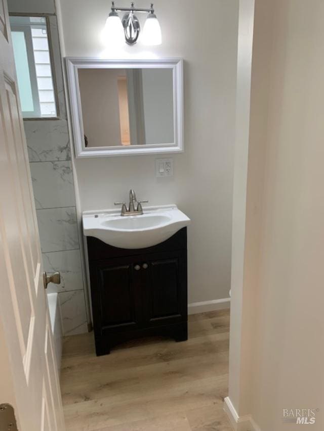 bathroom with vanity and hardwood / wood-style flooring