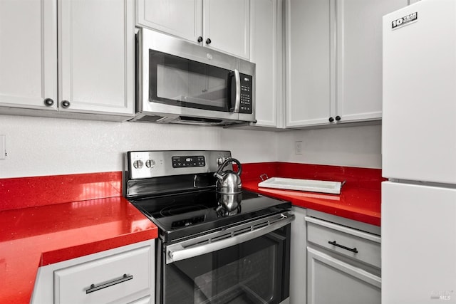 kitchen featuring appliances with stainless steel finishes and white cabinetry