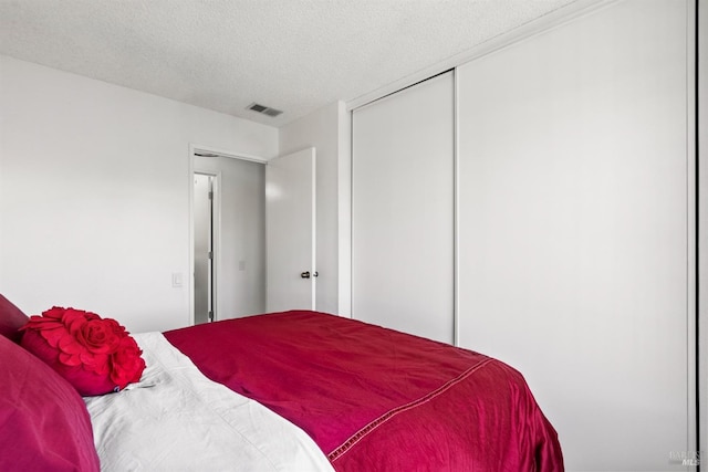 bedroom with a closet and a textured ceiling