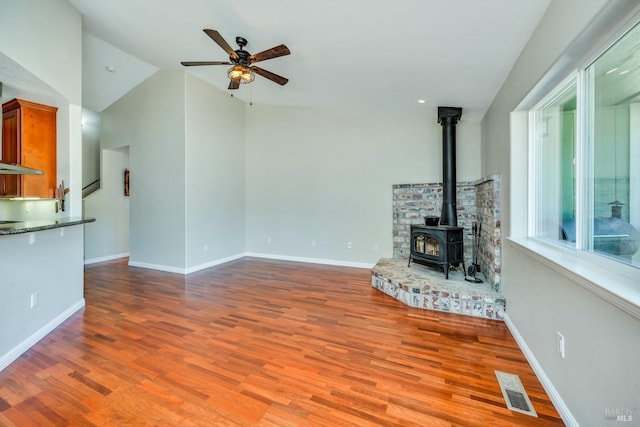 unfurnished living room featuring lofted ceiling, ceiling fan, and light wood-type flooring