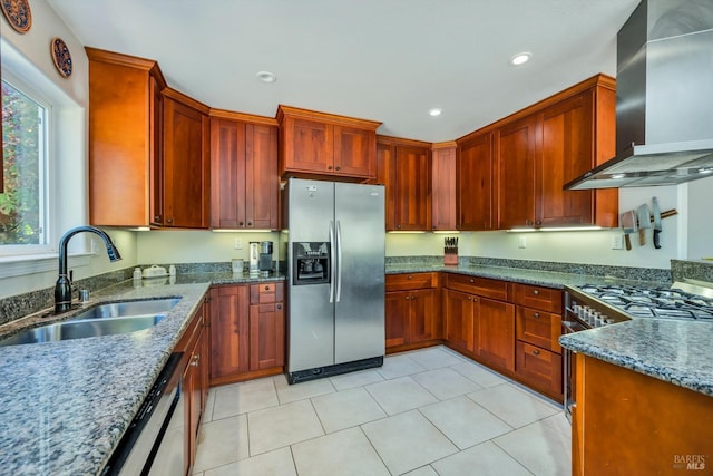 kitchen featuring dark stone countertops, sink, wall chimney exhaust hood, and appliances with stainless steel finishes