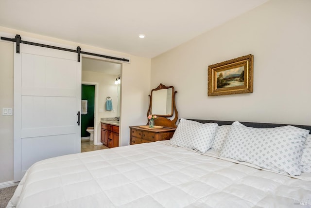 bedroom with a barn door and ensuite bath