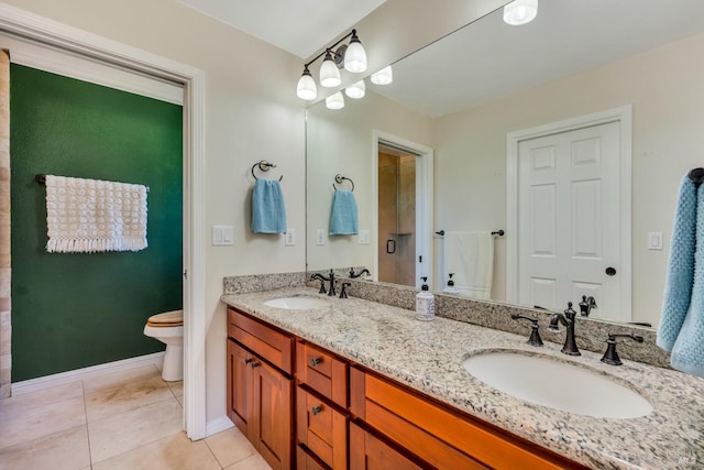 bathroom with tile patterned flooring, vanity, a shower with door, and toilet