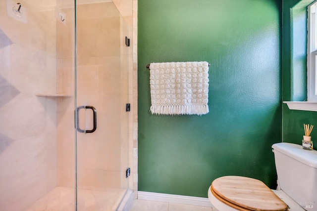 bathroom with tile patterned floors, a shower with shower door, and toilet