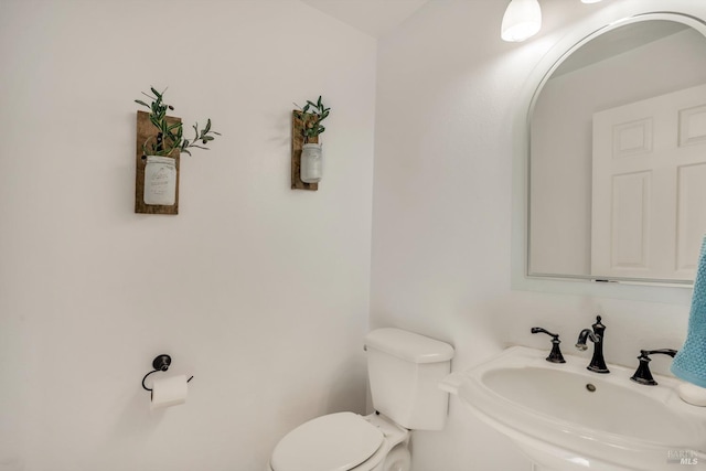 bathroom with toilet and sink