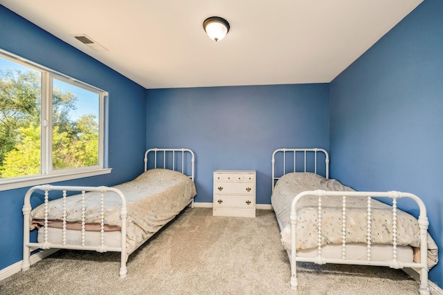 bedroom featuring light carpet