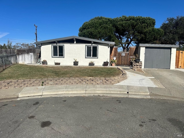 view of front of house featuring a front yard and a shed