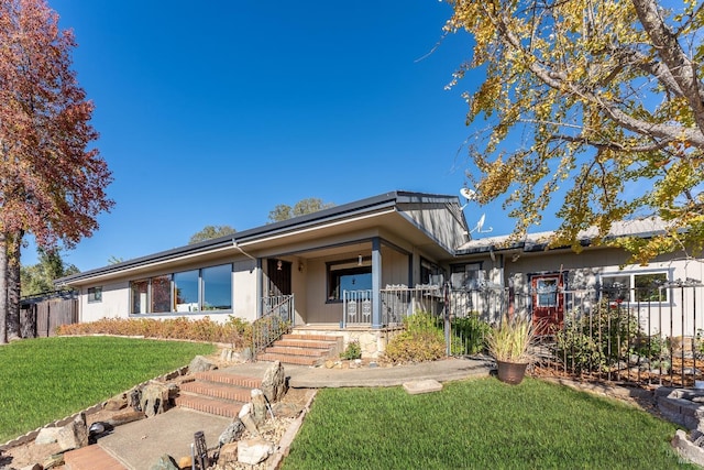 view of front of house featuring covered porch and a front lawn