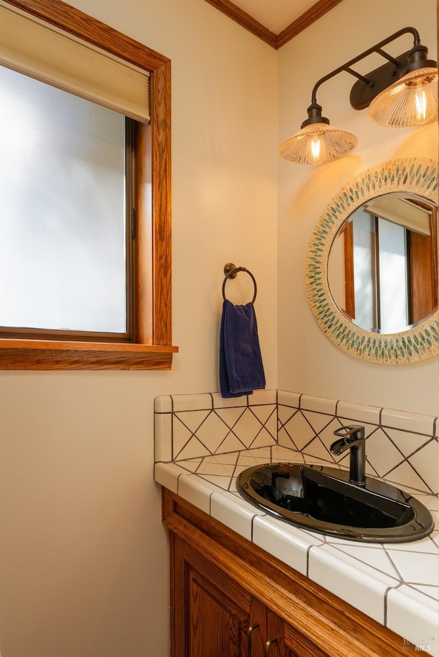 bathroom featuring decorative backsplash, vanity, and crown molding