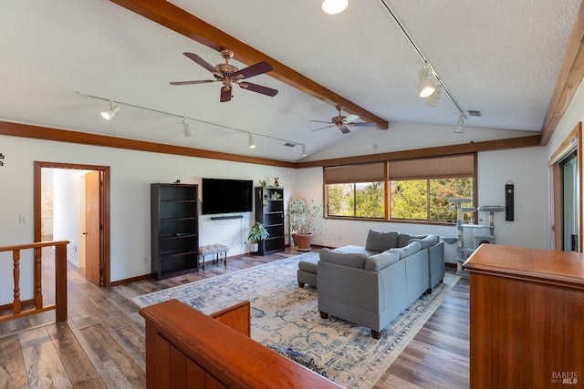 living room featuring vaulted ceiling with beams, a textured ceiling, ceiling fan, and dark wood-type flooring