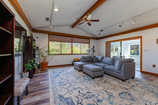 living room with wood-type flooring, a textured ceiling, vaulted ceiling, and ceiling fan