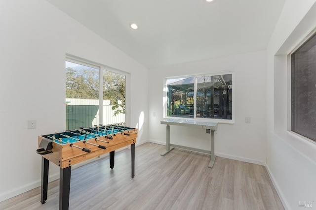 recreation room featuring light wood-type flooring and lofted ceiling