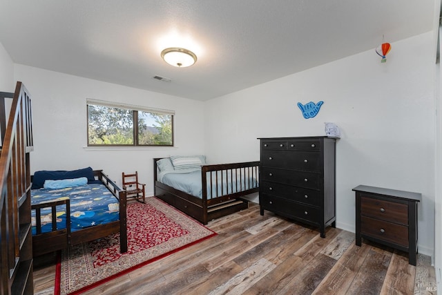 bedroom featuring dark wood-type flooring